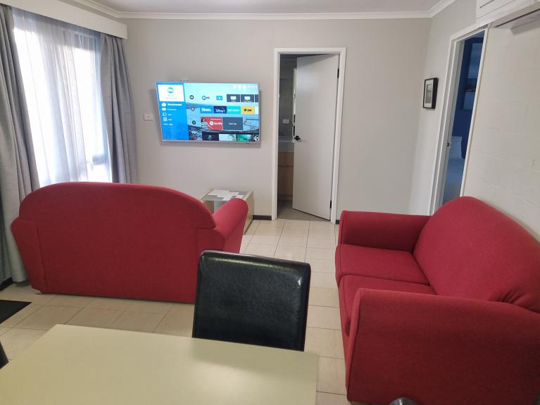 Two bedroom apartment 1 king 2 singles beds Best Western Apollo Bay lounge with cast TV